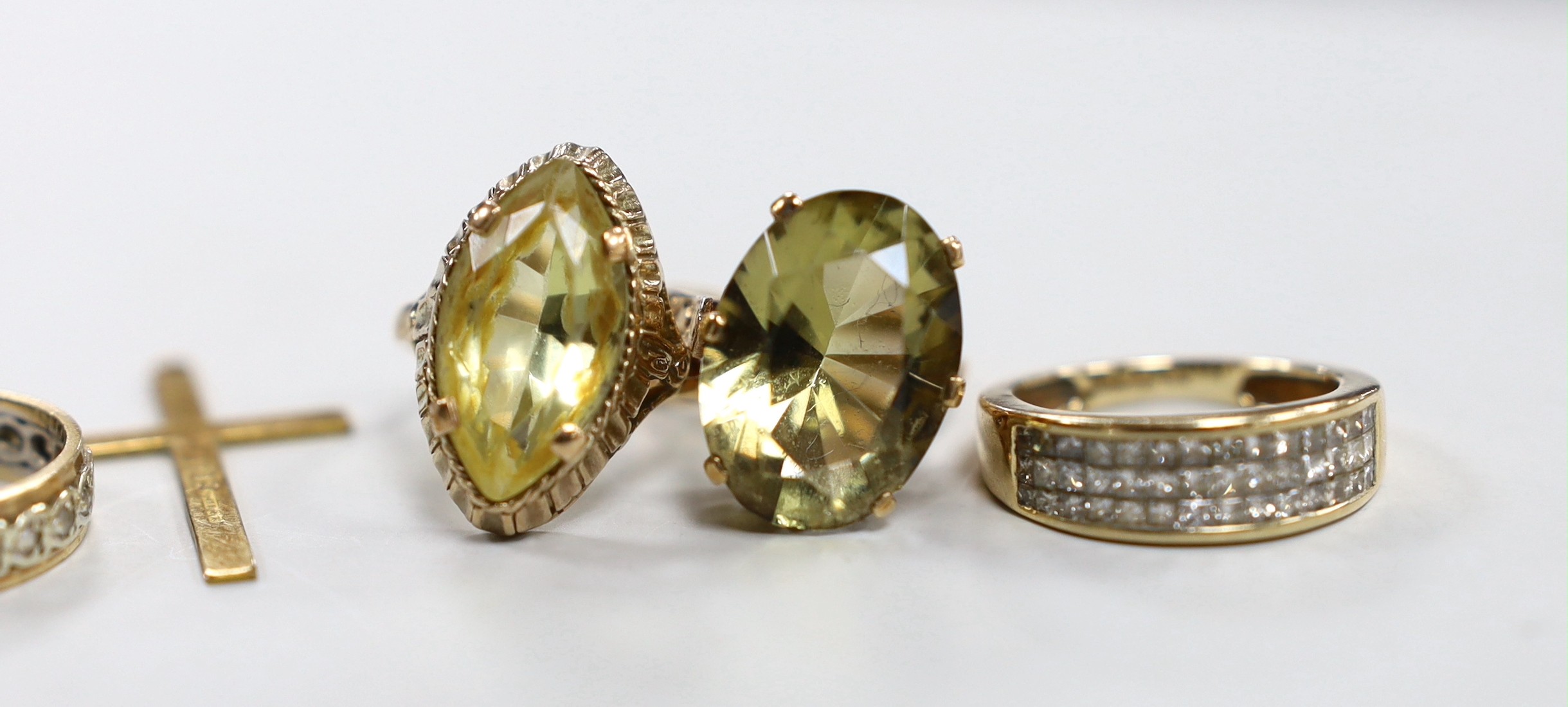 Three 9ct gold and gem set rings, gross 13.4 grams, a 9ct gold cross and one other yellow metal ring.